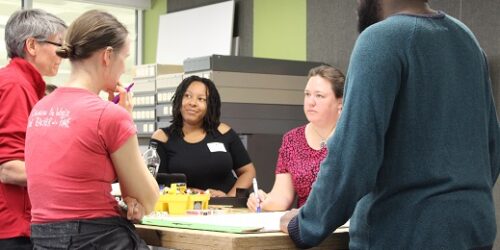 an inclusive group of adults around a table